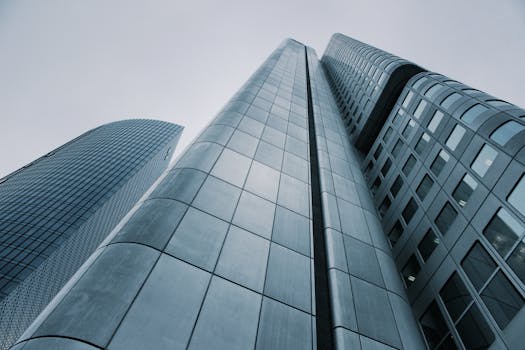 Low angle view of modern skyscrapers with glass and steel design. Perfect for corporate imagery.